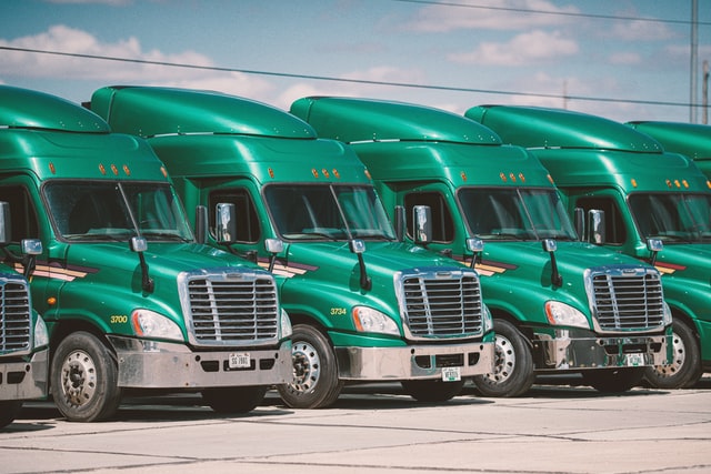 Image of green trucks in a row