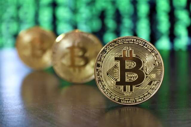 Image of three bitcoins in a row