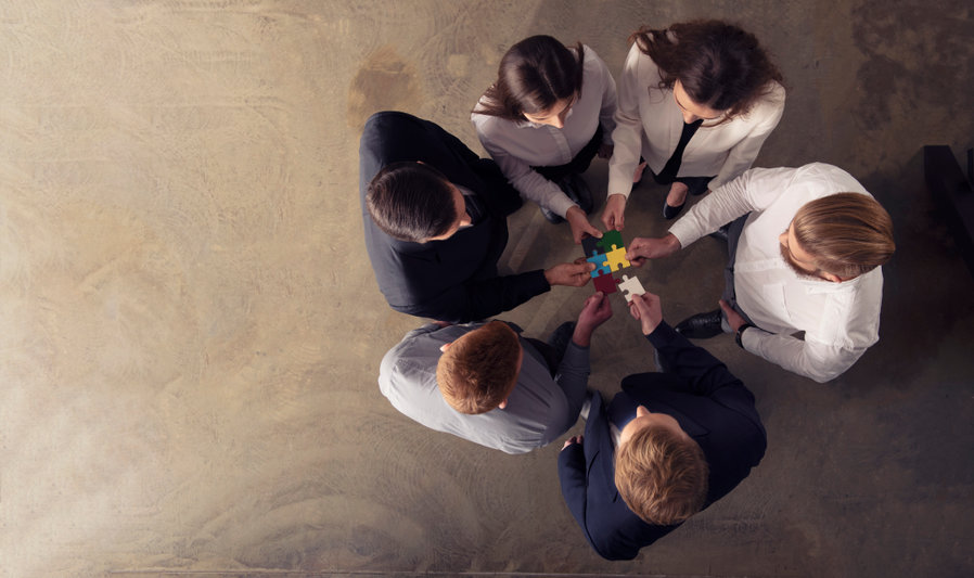 Image of group joining jigsaw pieces together