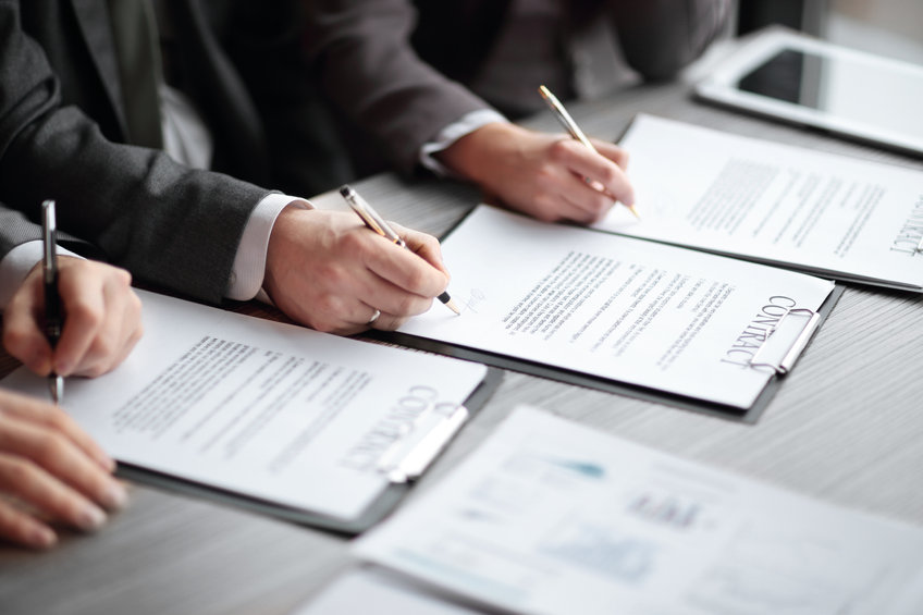Image of business people signing a joint statement