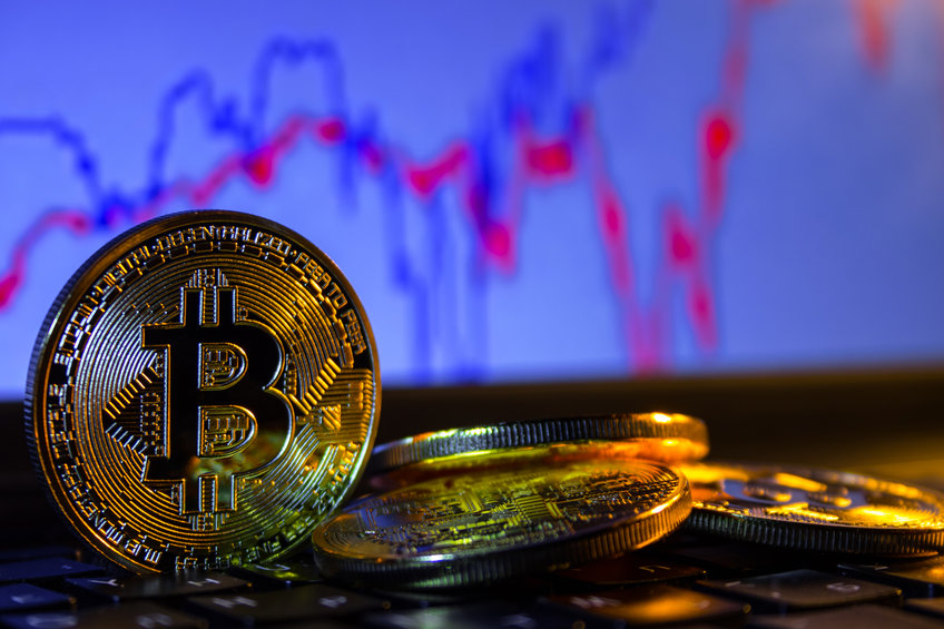 Image of Bitcoin with charts in the background