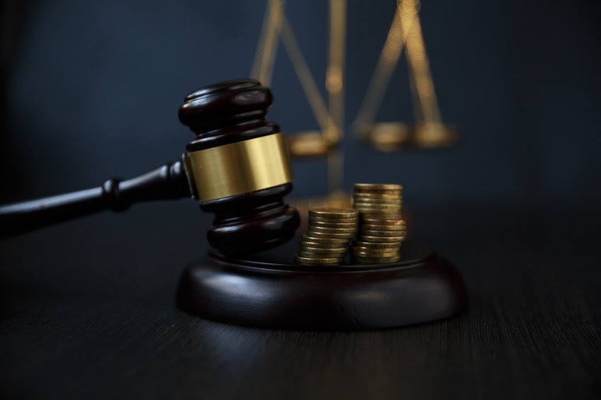 Image of a gavel with coins on it