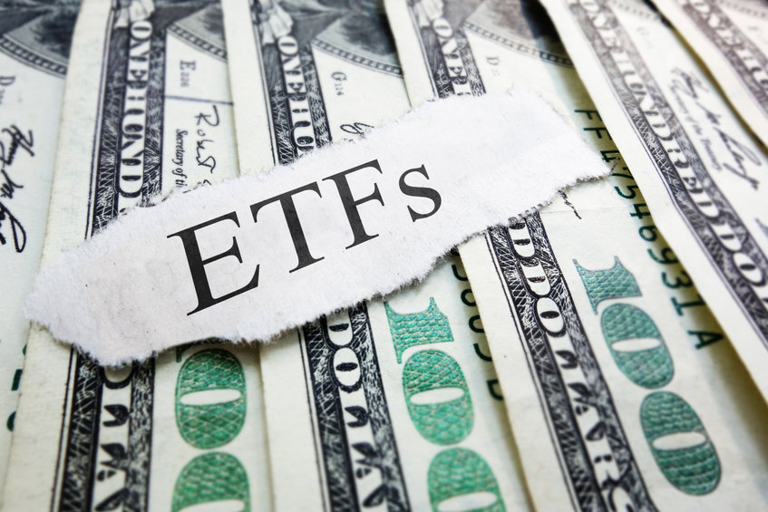 Image of an ETF paper on top of dollar bills