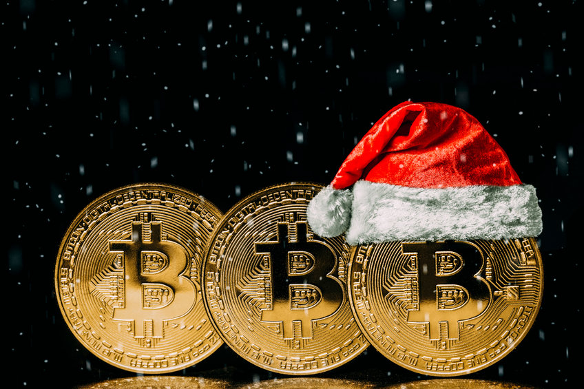Image of Bitcoins, one with a Santa hat