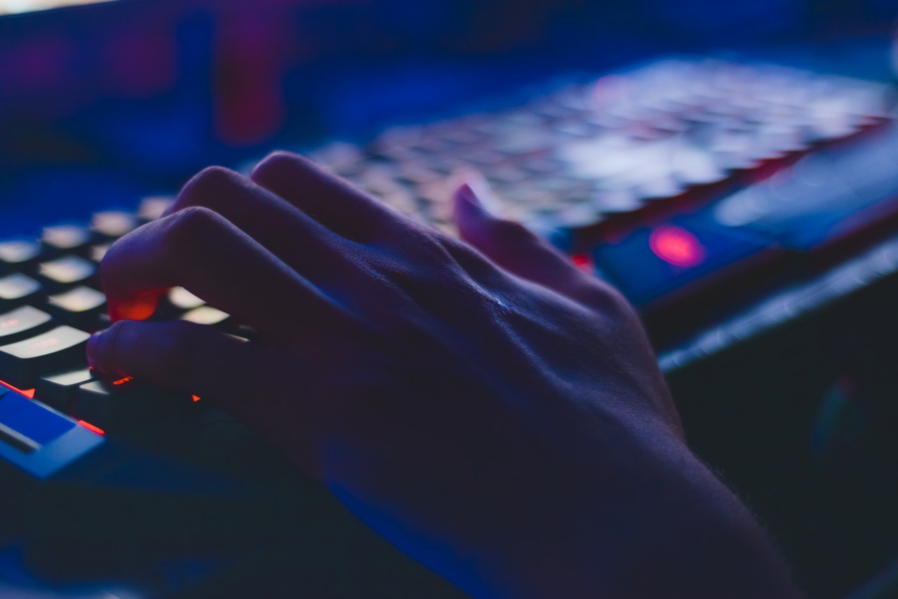 A man's hand over a keyboard.