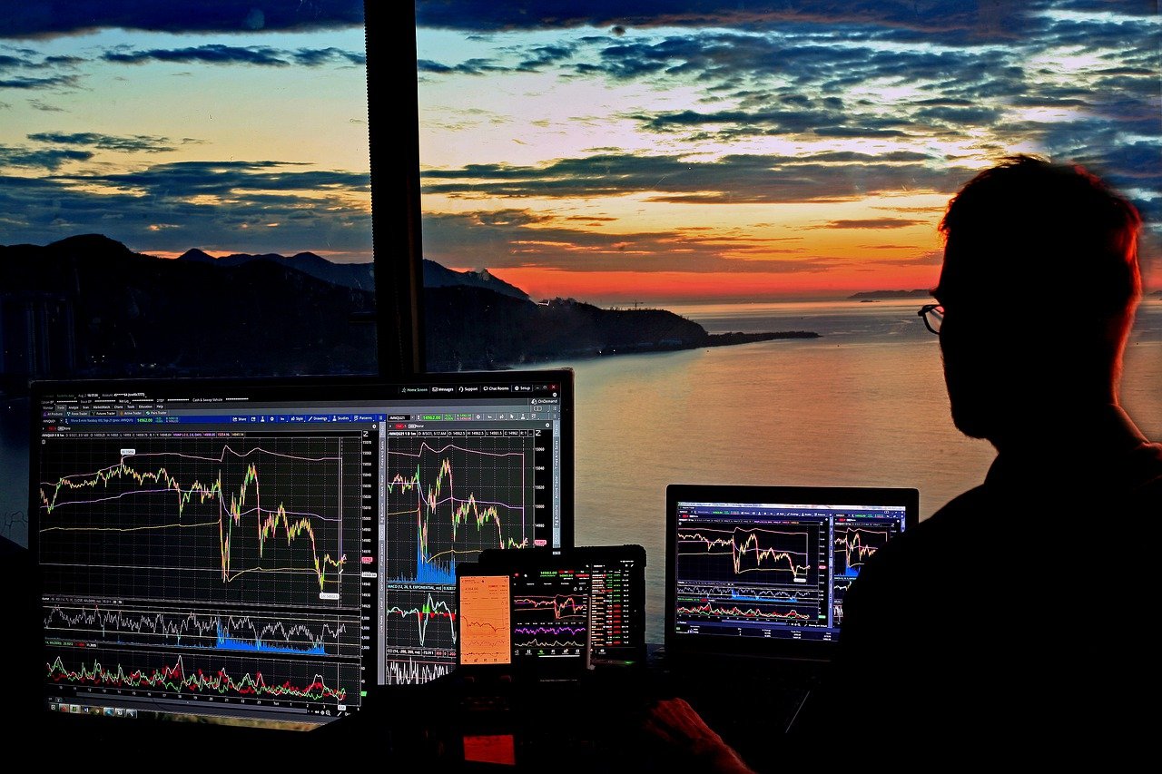 A man with stock trading charts.