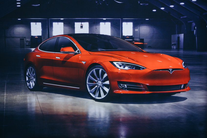 Photo of the image of an electric vehicle Tesla at the Tesla motor show in Berlin. A modern electric car.