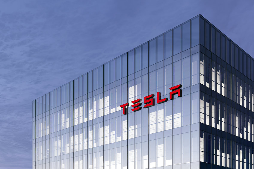 Tesla Signage Logo on Top of Glass Building. Workplace Car Company Office Headquarter.