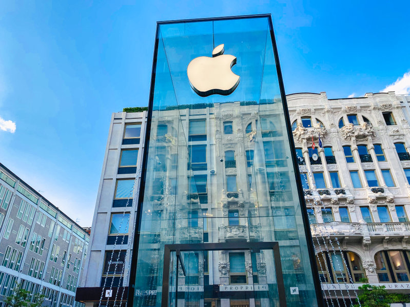 Apple logo on a city-light-like glass post towering over the viewer