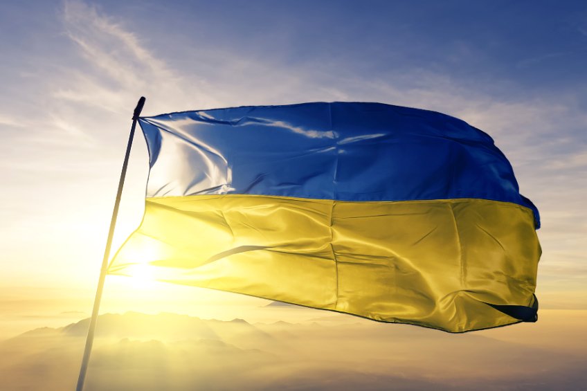 Flag of Ukraine against the sun in the background