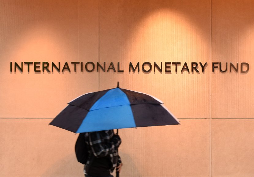 pedestrian with an umbrella near international monetary fund, imf headquarters