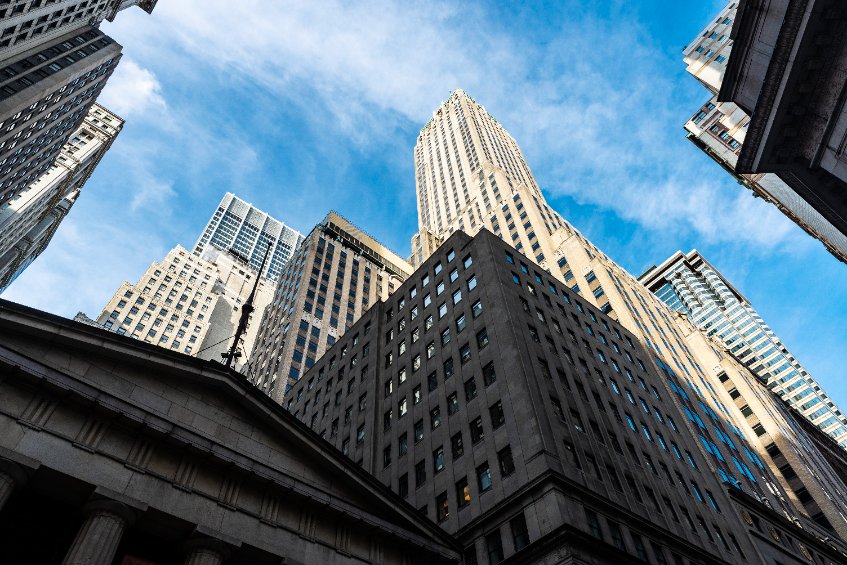 Facade of the federal hall national memorial and other buildings on wall street in lower manhattan