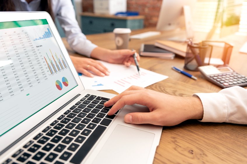 financial advisor with laptop and graph on the screen