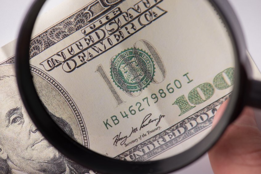 $100 Bank Note Under Magnifying Glass