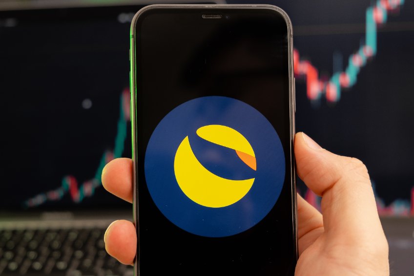 Terra luna cryptocurrency logo on the screen of a smartphone in mans hand