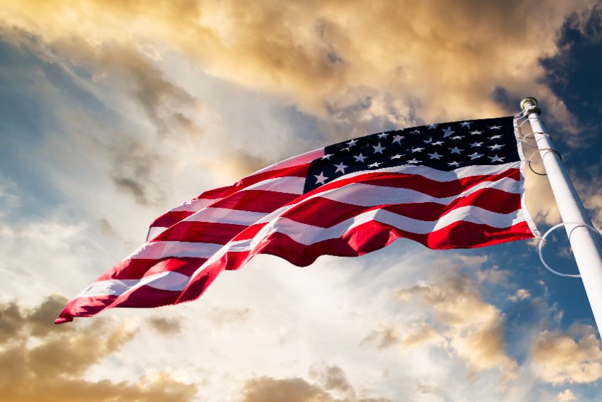 American flag waving blue sky