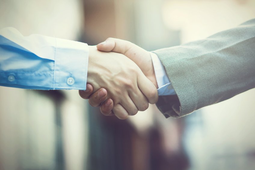 Business handshake. two businessman shaking hands as deal ends