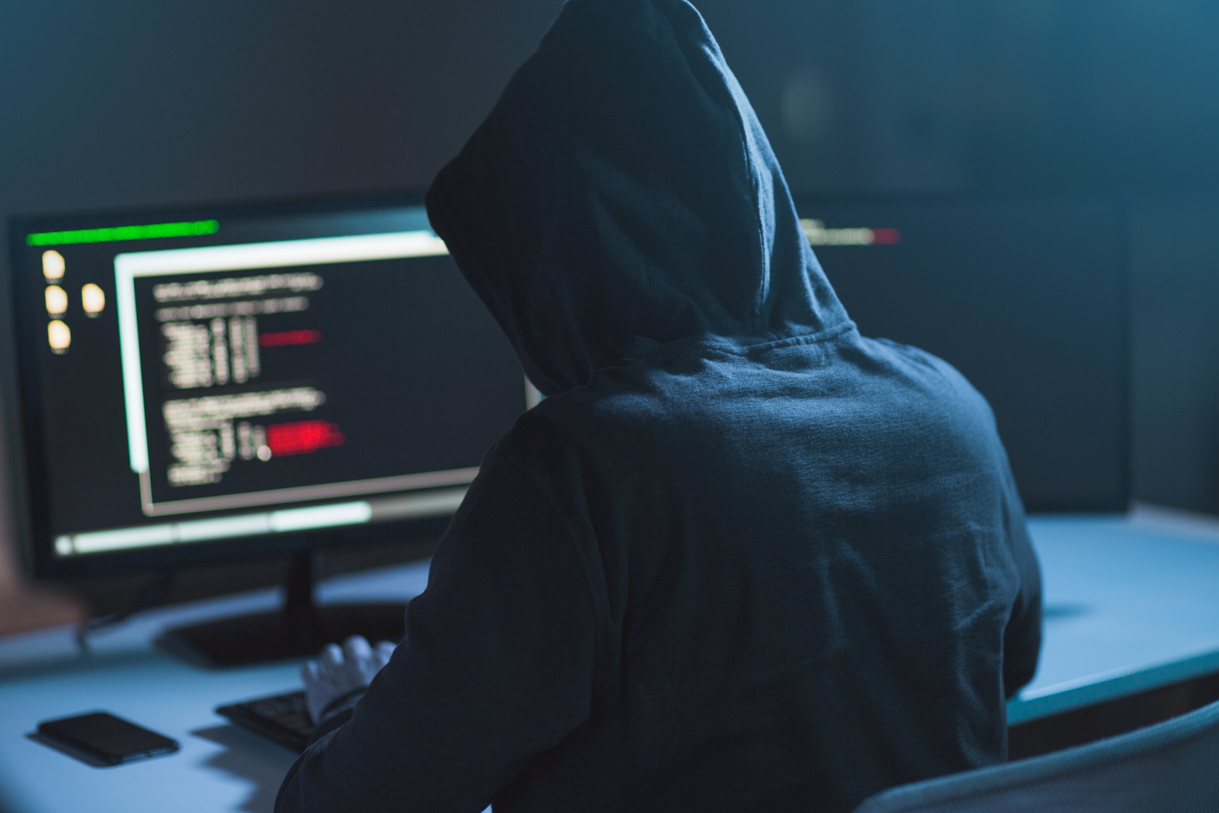 A hooded hacker in action.