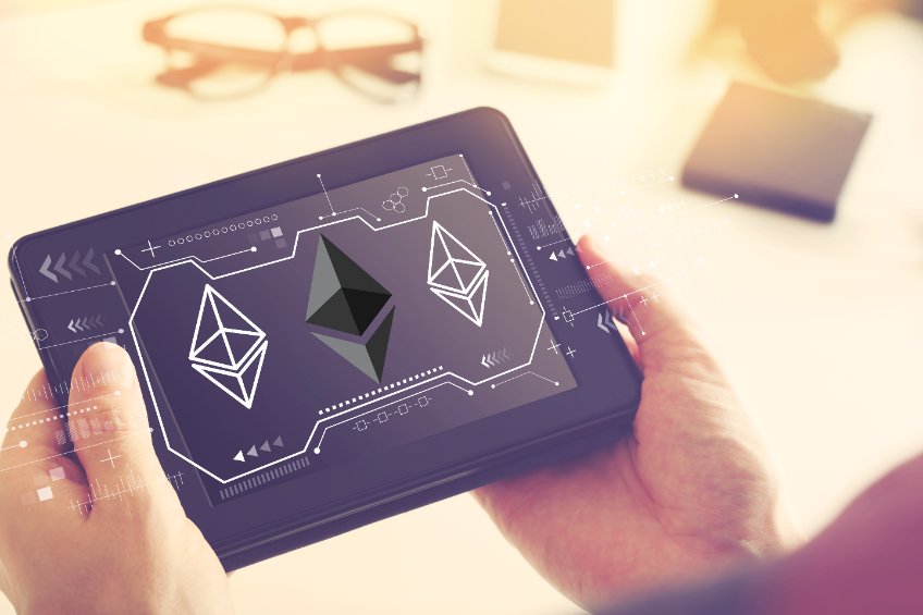 Ethereum with man holding a tablet computer