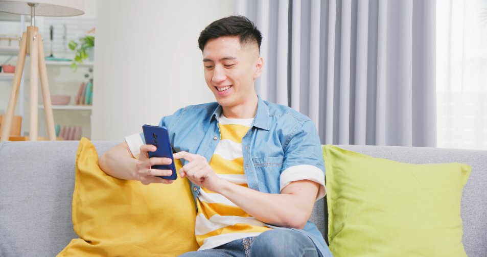 asian young man sitting on sofa