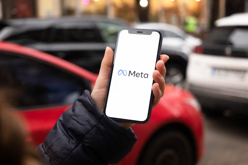 Meta the new Facebook name and logo. Hand with mobile phone