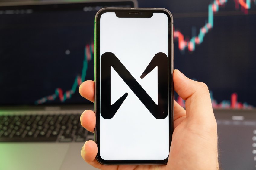 NEAR Protocol cryptocurrency on the screen of a smartphone in mans hand