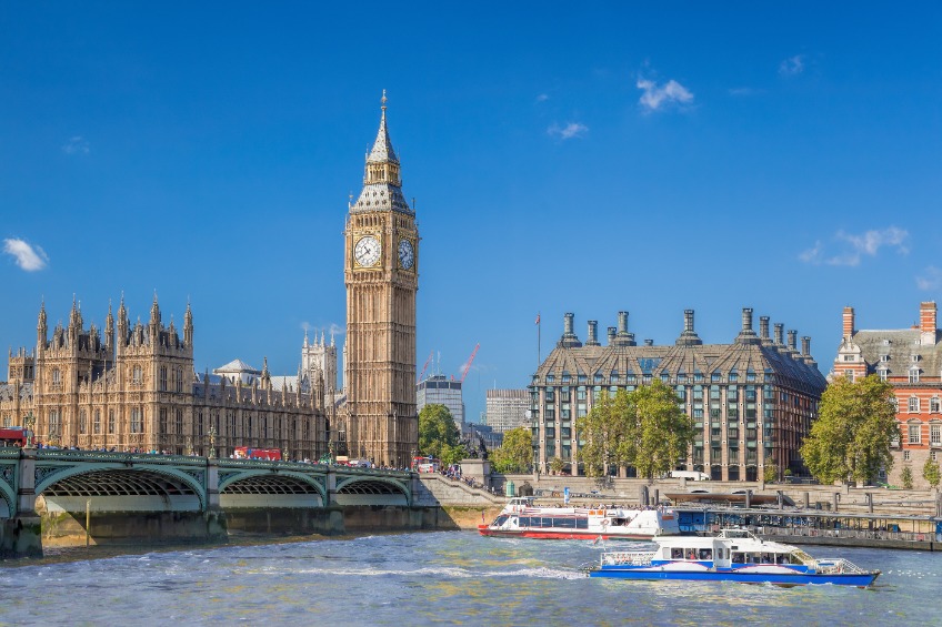Big Ben and Houses of Parliament with boats on the river in London, England, UK