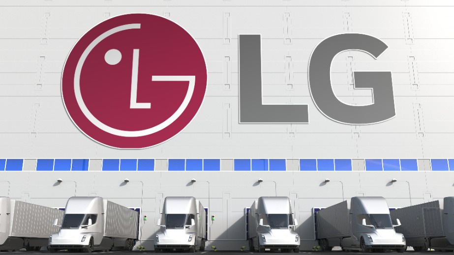 Electric semi-trailer trucks at warehouse loading bay with LG logo on the wall.