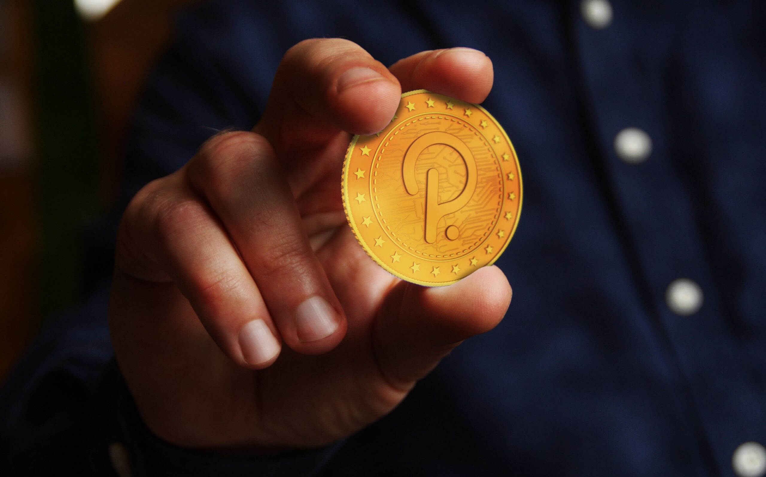 DOT token held in a hand by a person in a suit.