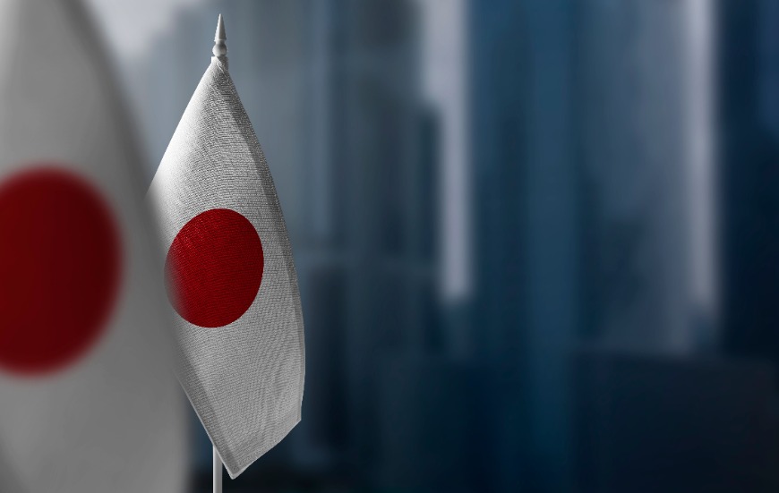 Small flags of Japan on a blurry background of the city