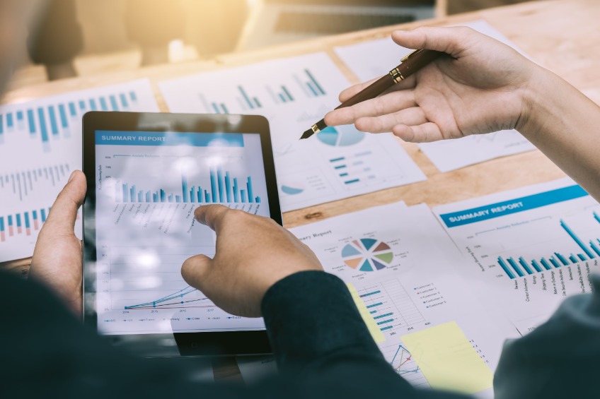 Business people analysis with graph on digital tablet