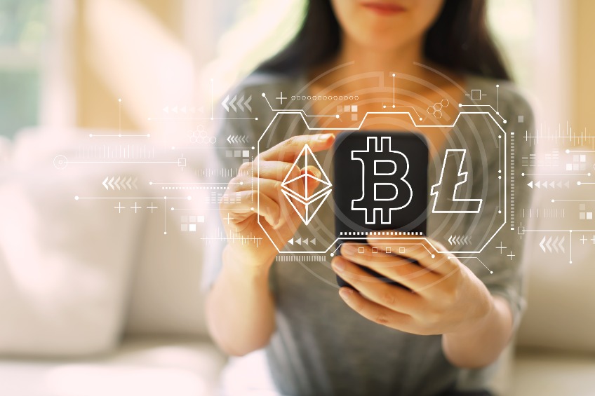 Cryptocurrency - Bitcoin, Ethereum, Litecoin with woman using her smartphone in a living room