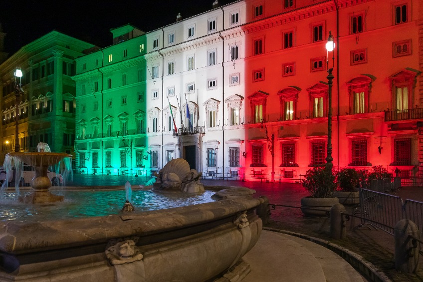 Palazzo Chigi, seat of the Italian government, facade of the building illuminated with the colors of the Italian flag