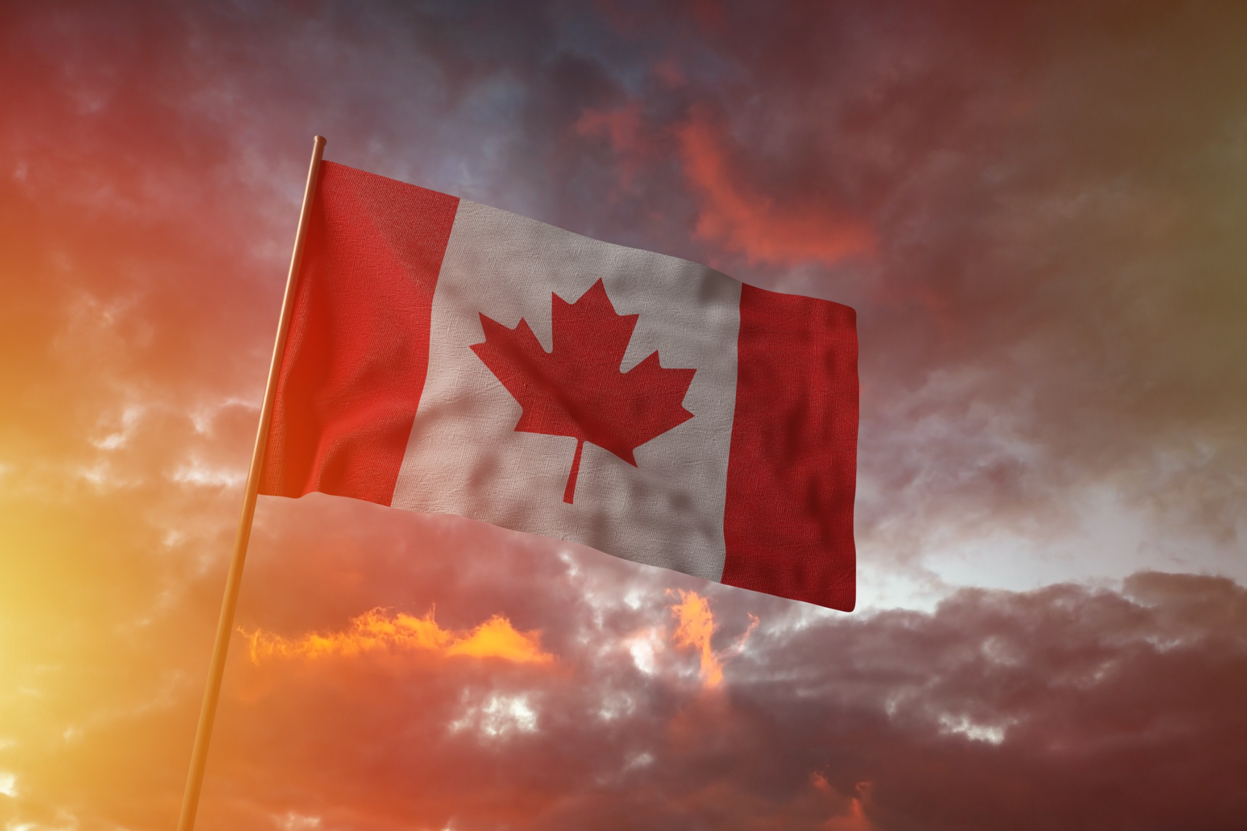 Canadian flag on a pole under a rather dramatic sky.