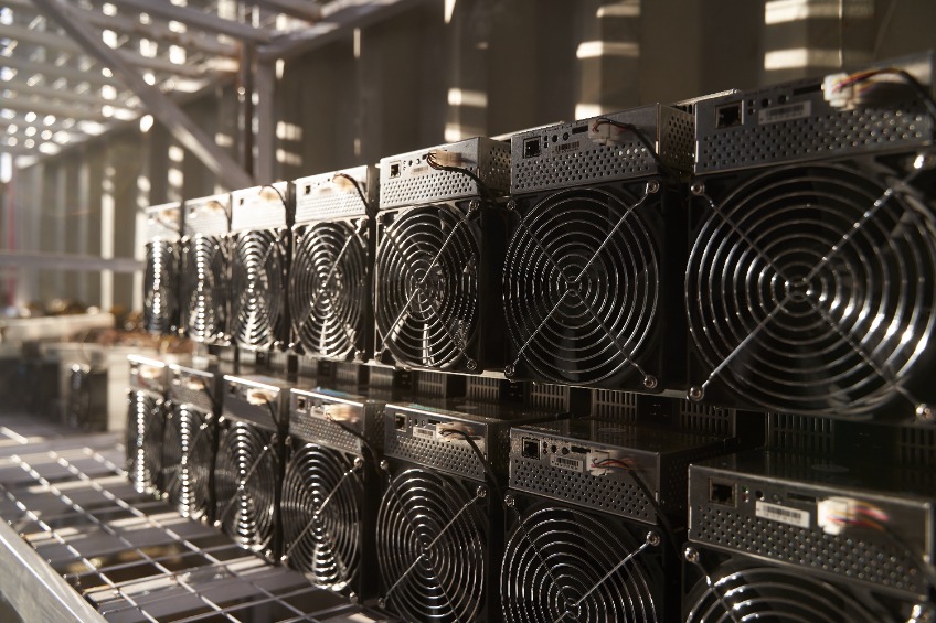 ASIC mining equipment on stand racks for mining cryptocurrency in steel container.