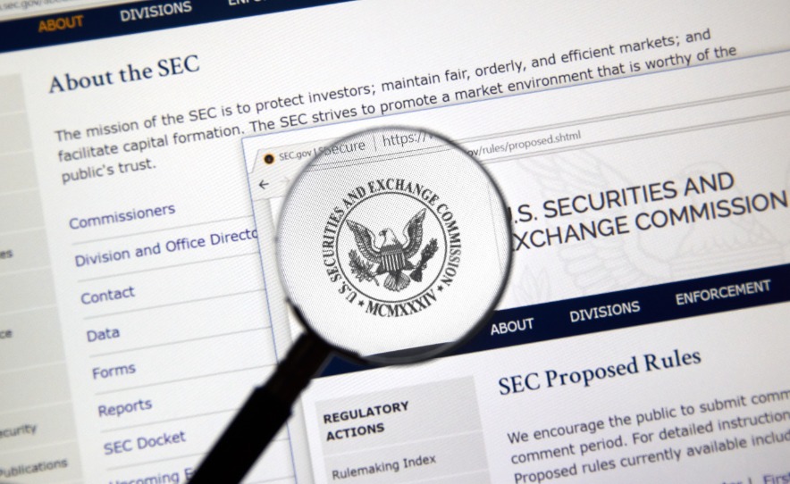 SEC webpage under magnifying glass.