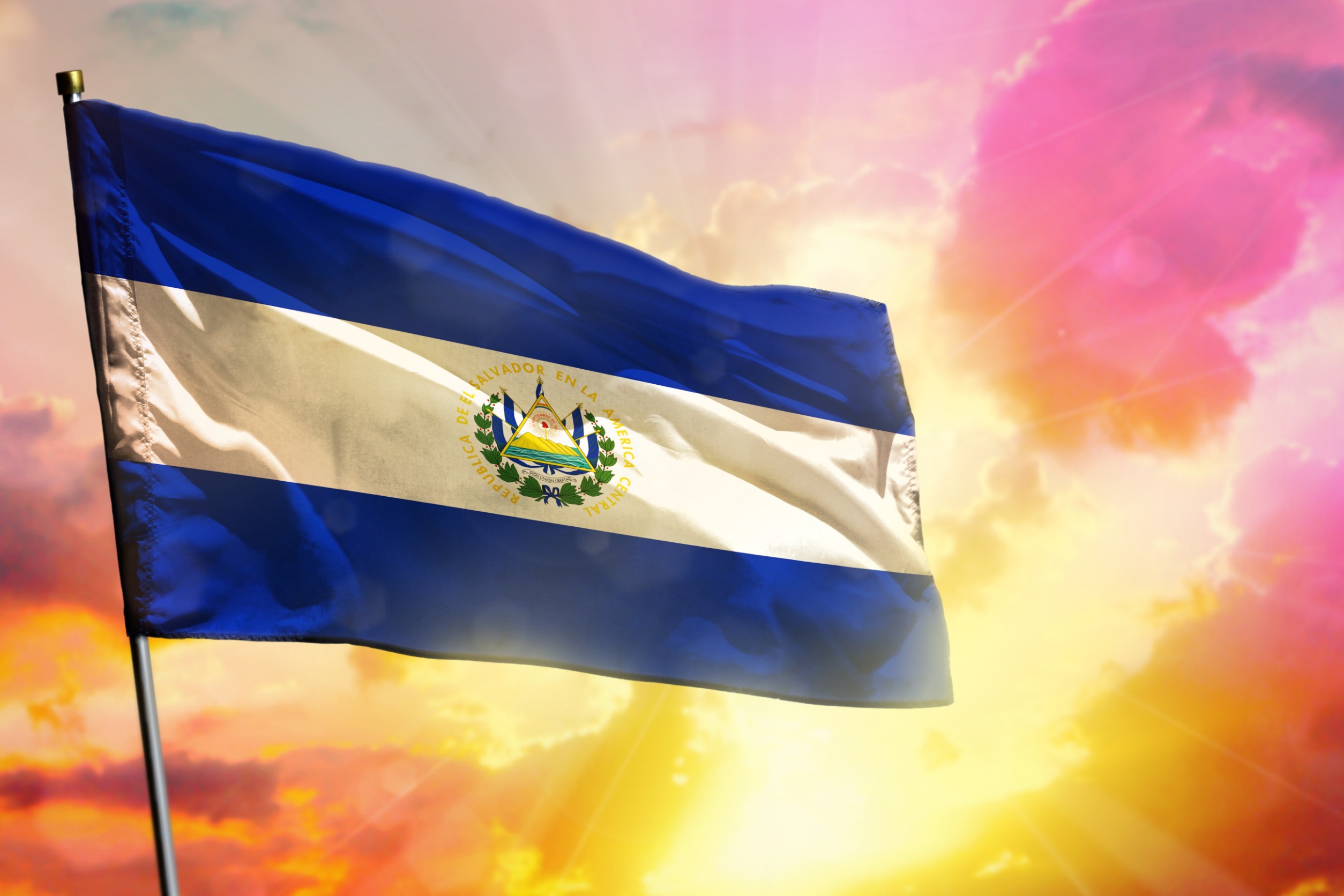 El Salvador's flag in front of a dynamic sky.