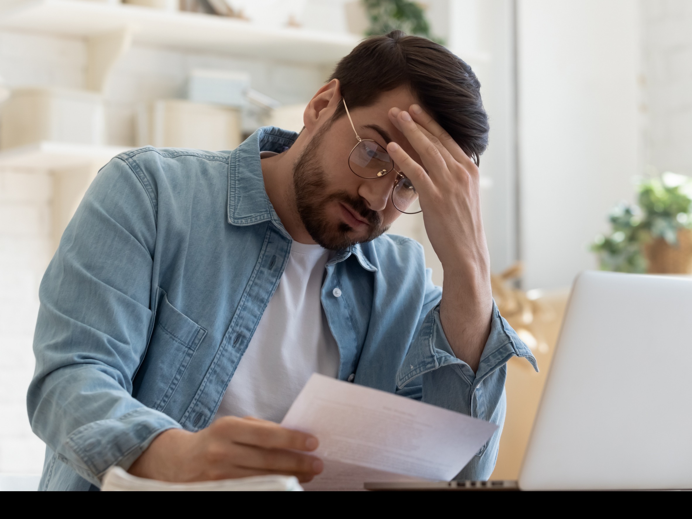 Upset man reading a letter