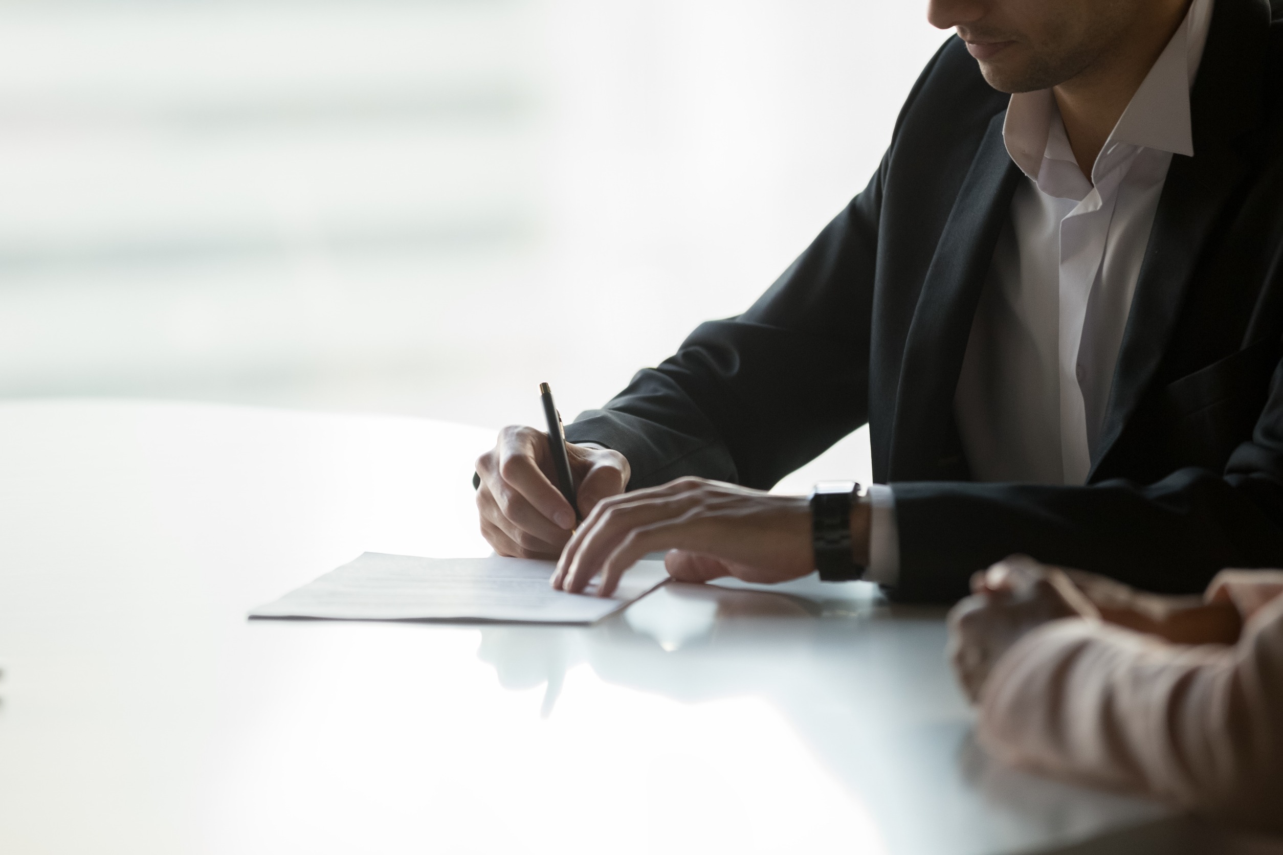Close up confident businessman signing contract, partnership agreement, client, customer putting signature on legal document, making successful business deal