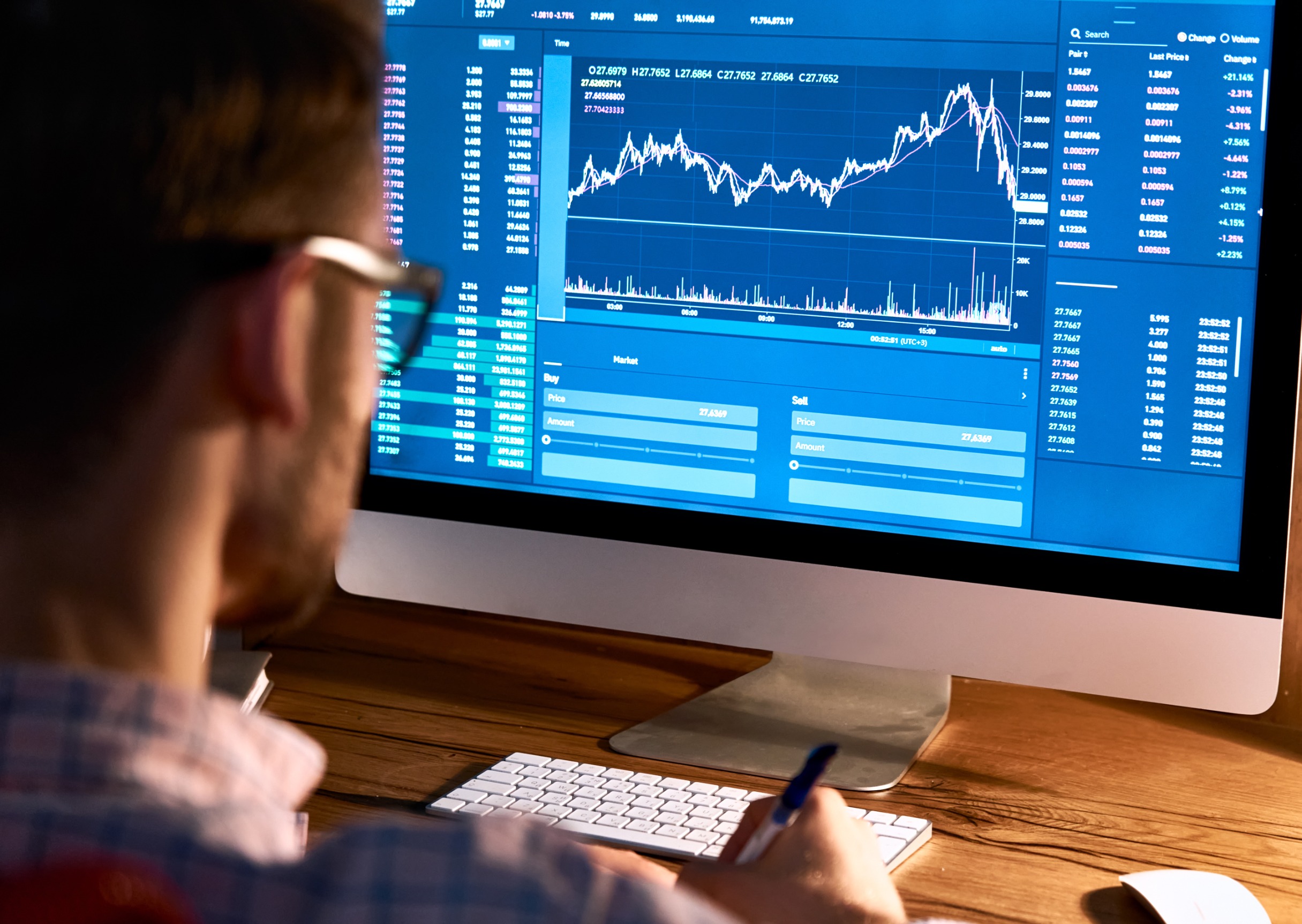 Stock market trader looking at computer trading online monitoring graph.