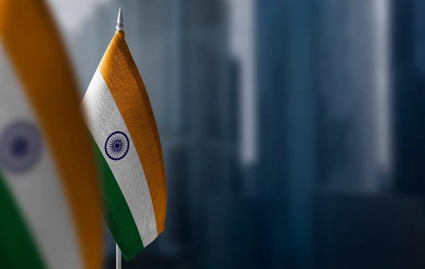 Small flags of India on a blurry background of the city