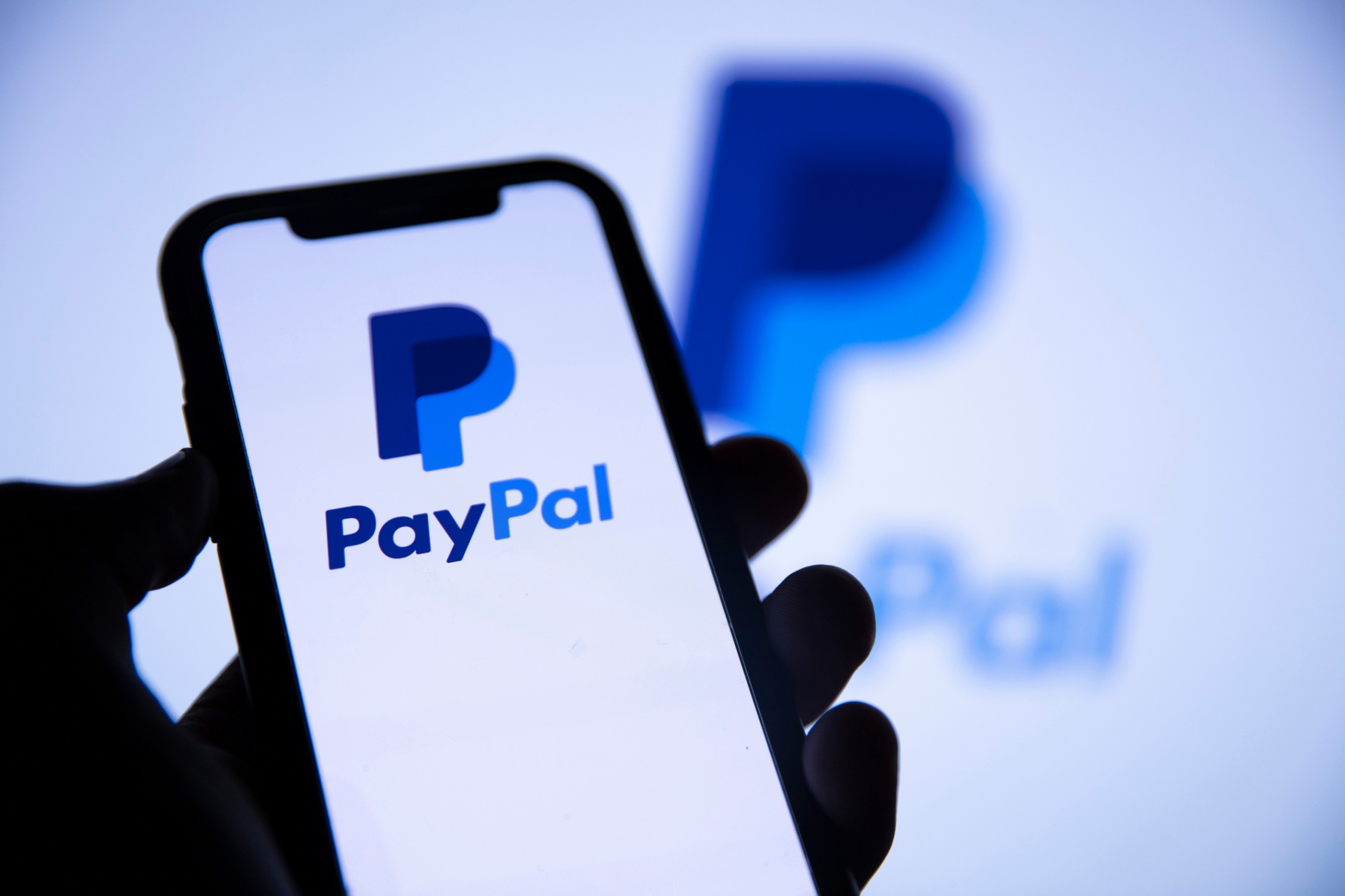 "PayPal" on a phone screen.