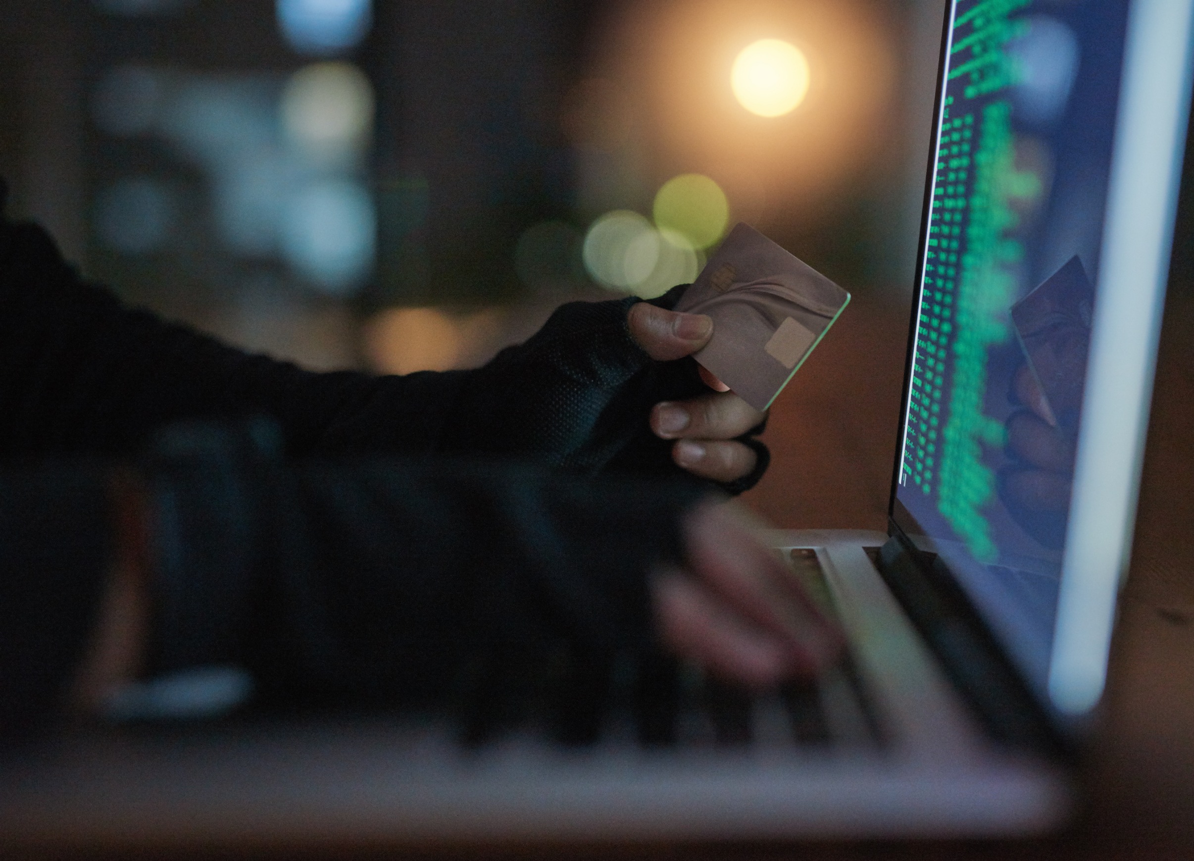 Hands of a hacker working on a laptop