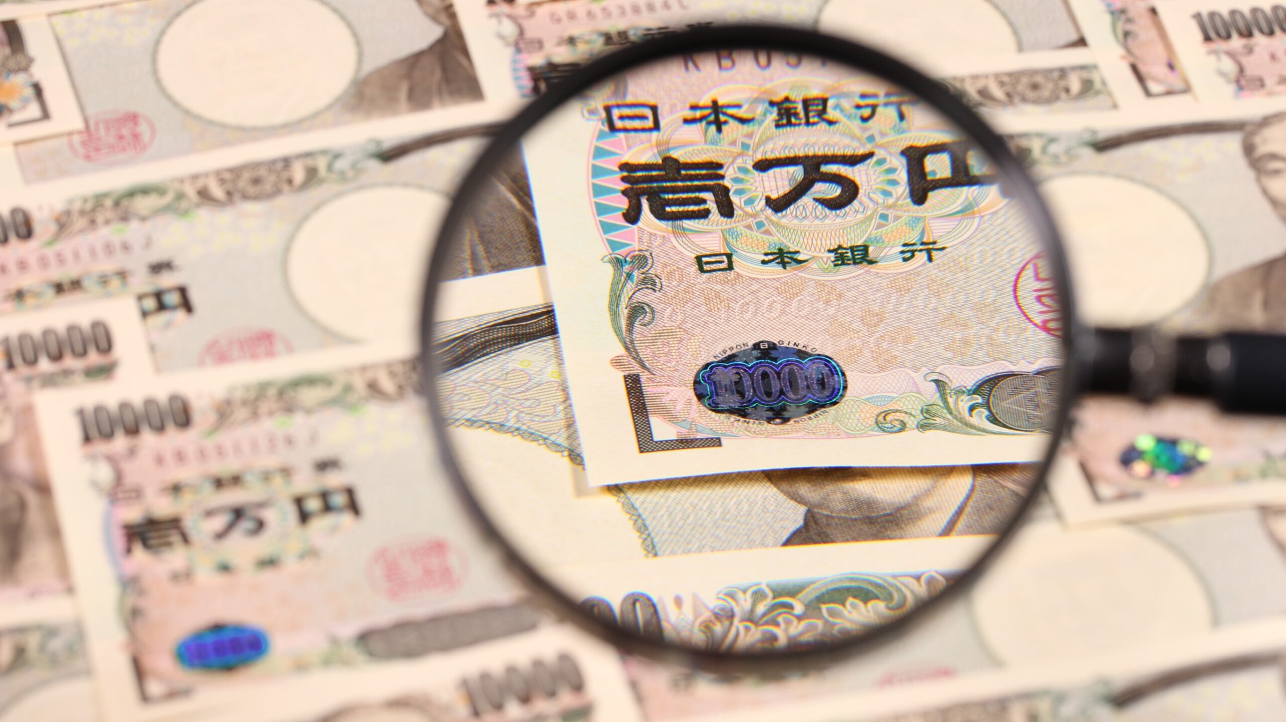 Japanese yen bill and magnifying glass