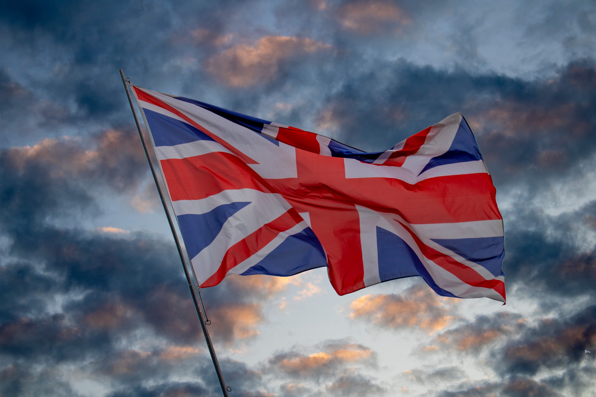 The british flag with dark clouds in the background.