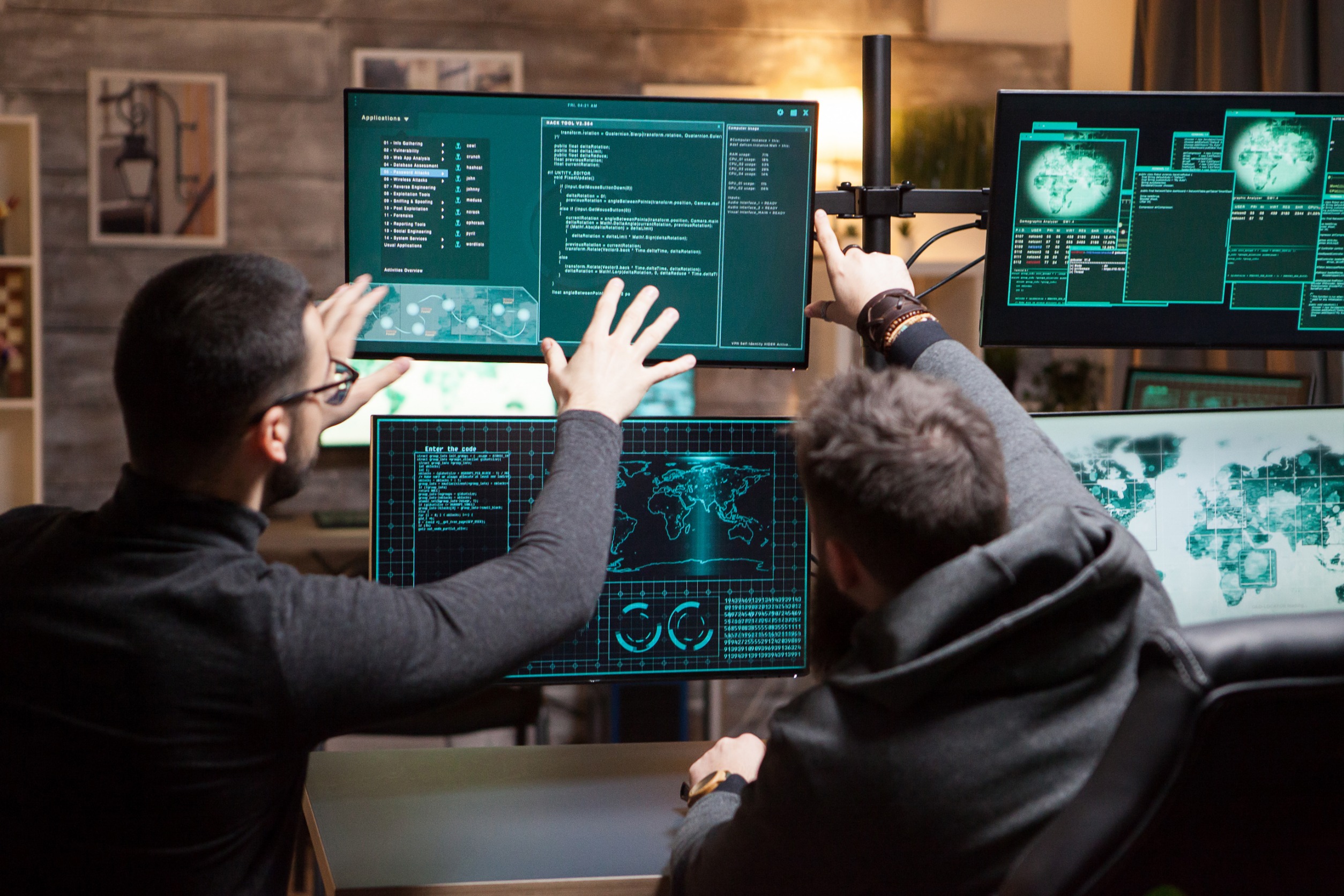 Men in front of computer screens.