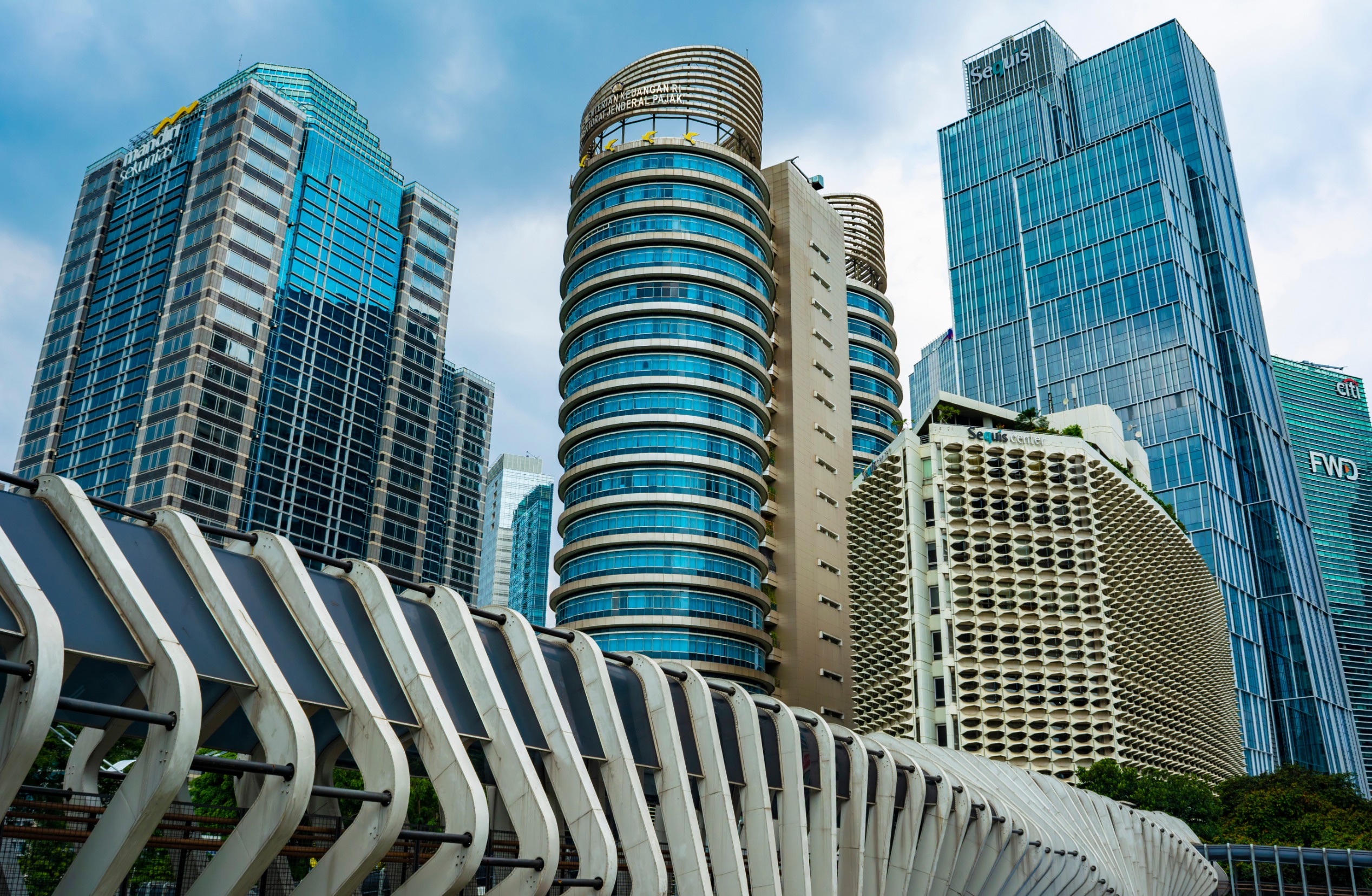 Buildings in Sudirman, which is Central Business District of Jakarta. There are banks, insurance, and ministry of finance buildings. Footbridge in foreground.