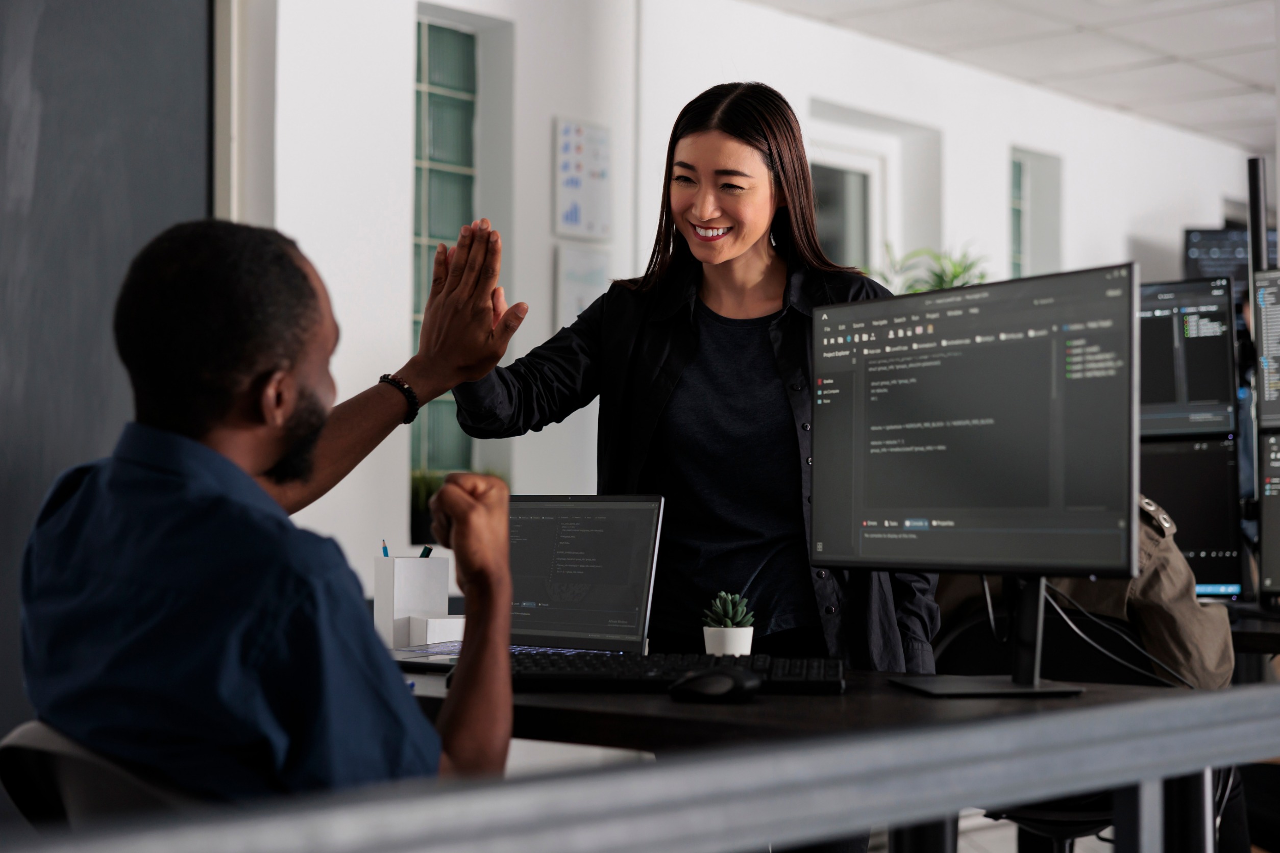 Happy developers doing a high five.
