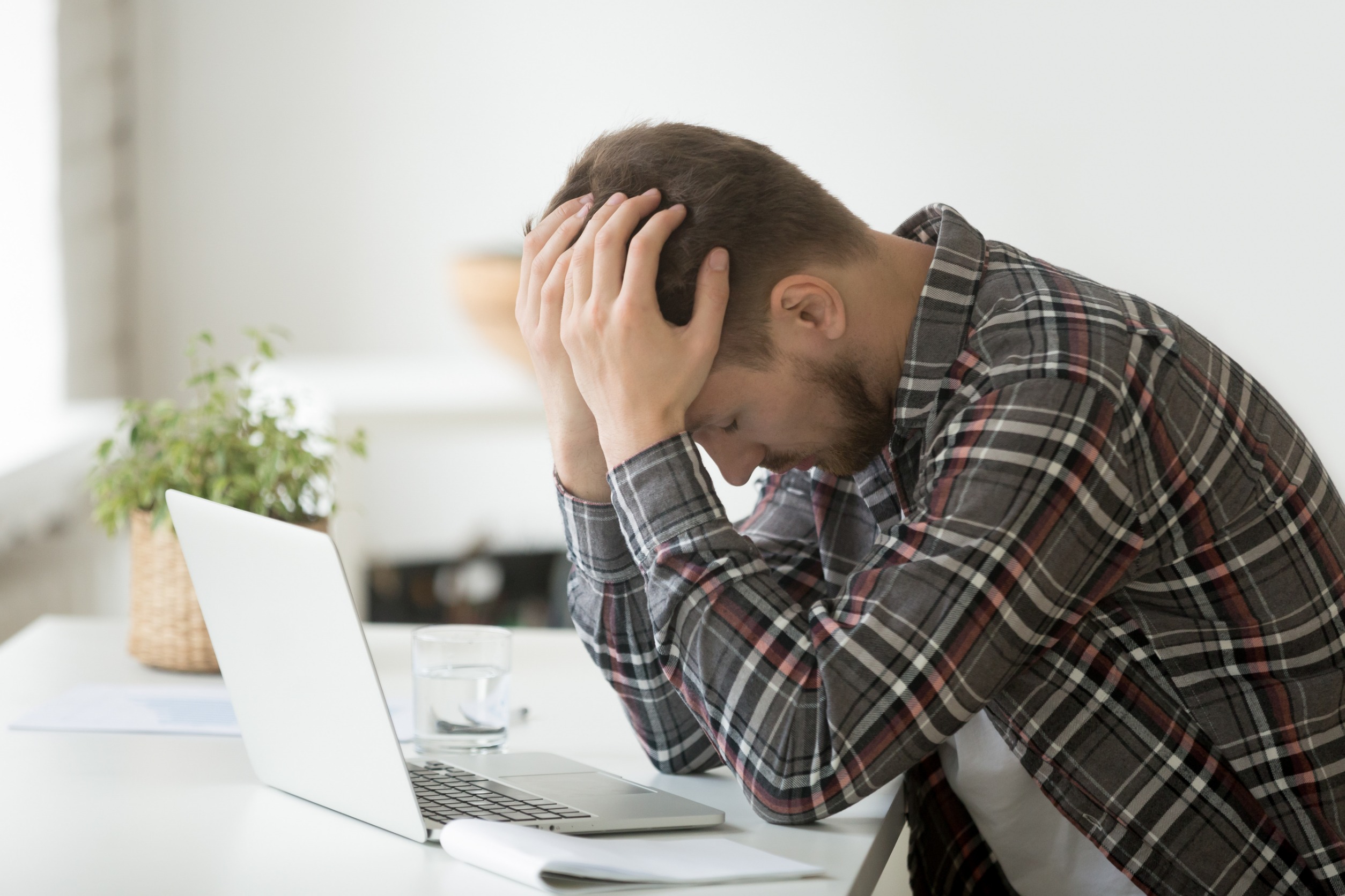 A desperate man in front of a laptop
