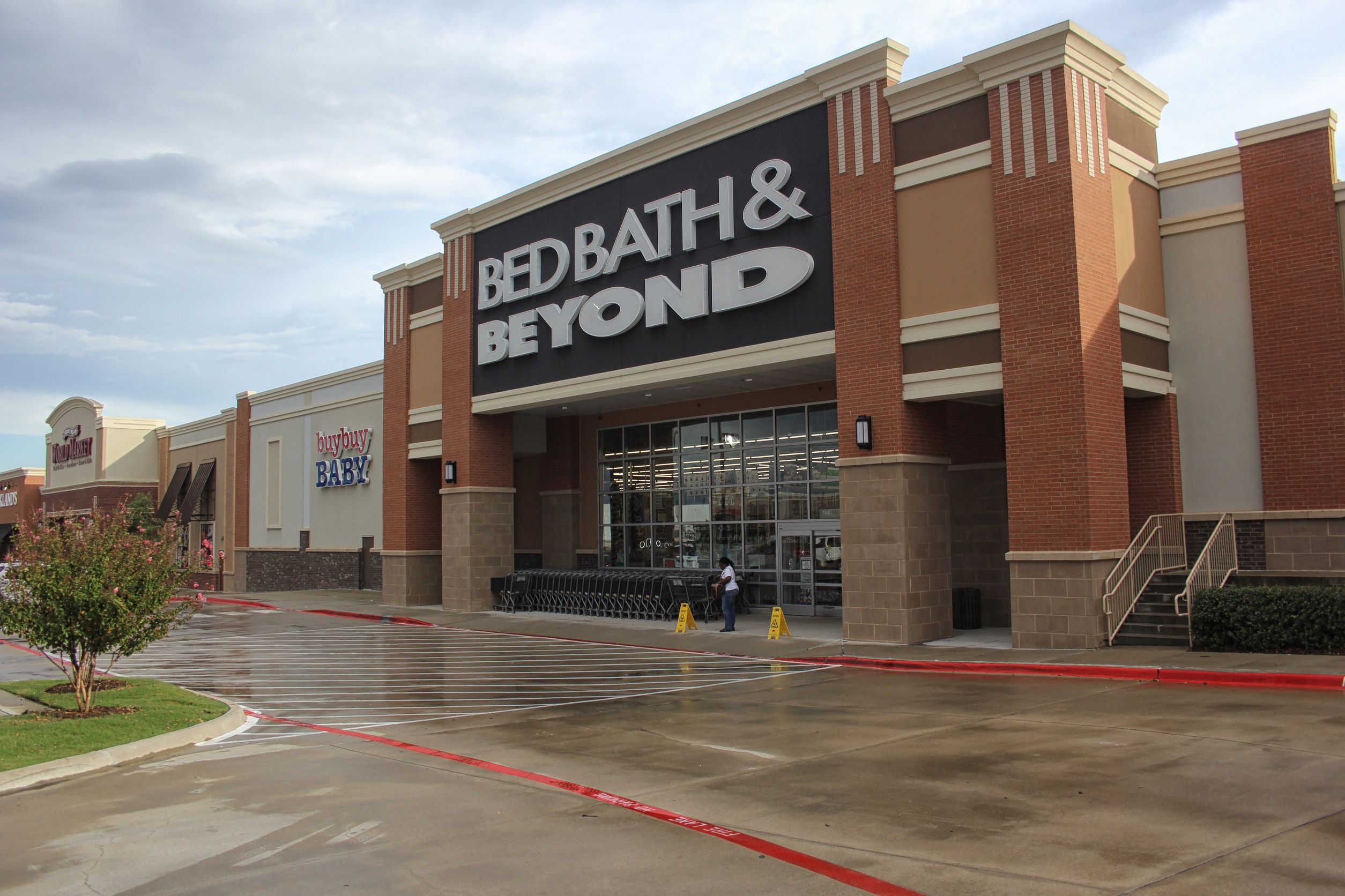 An empty parking lot in front of a BBBY store.